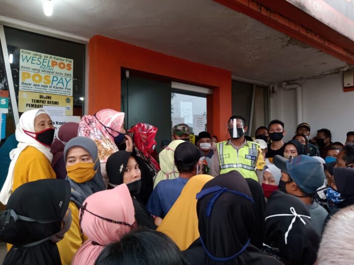 Pengamanan Penyaluran Bansos Kemensos Tahap Tiga Dilakukan oleh Bhabinkamtibmas Polsek Ciampea Dan Babinsa.